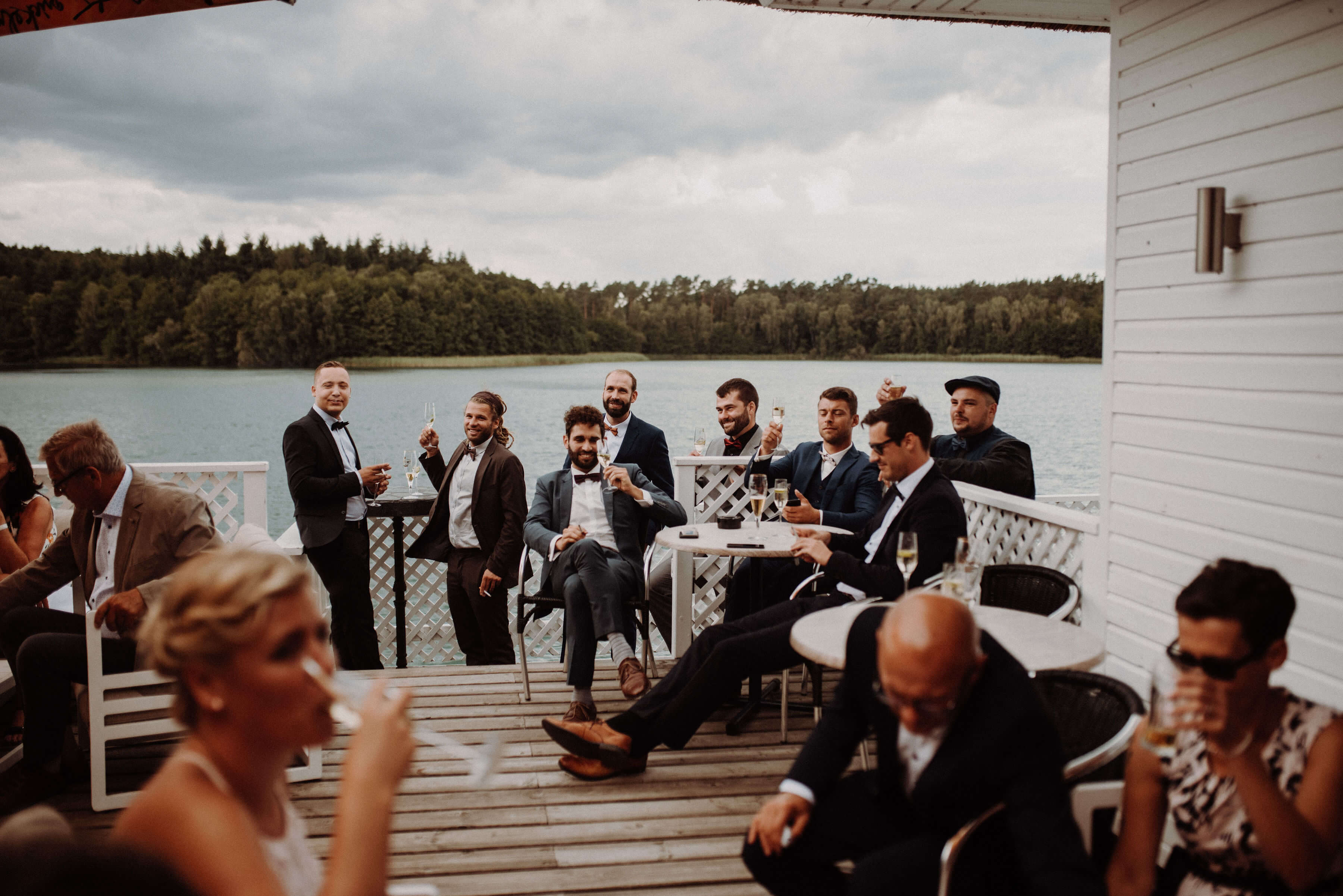 Sitzende Männer bei Hochzeit stoßen an